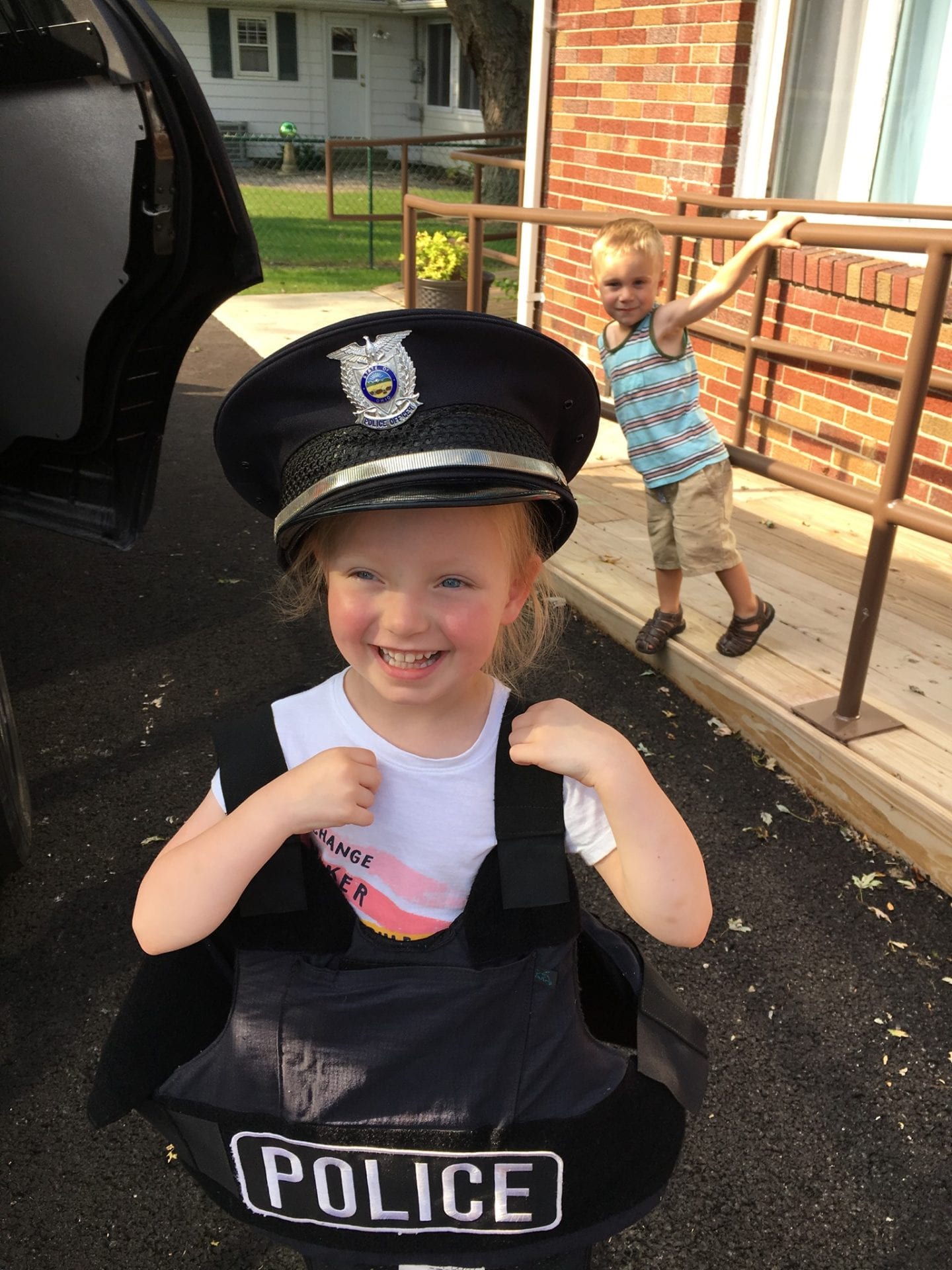A girl toddler wearing a police vest
